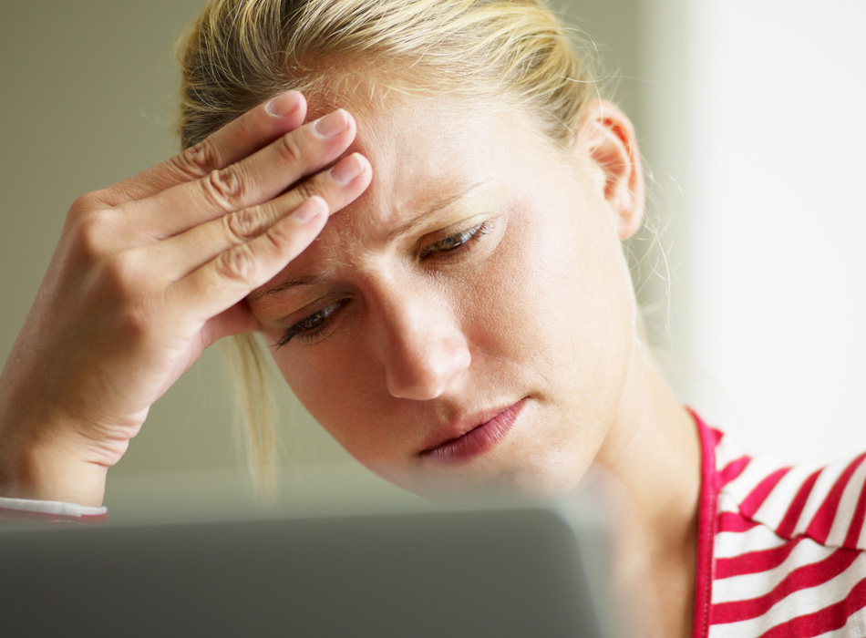 Upset woman looking at computer